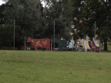Cut out cows along the fence Image